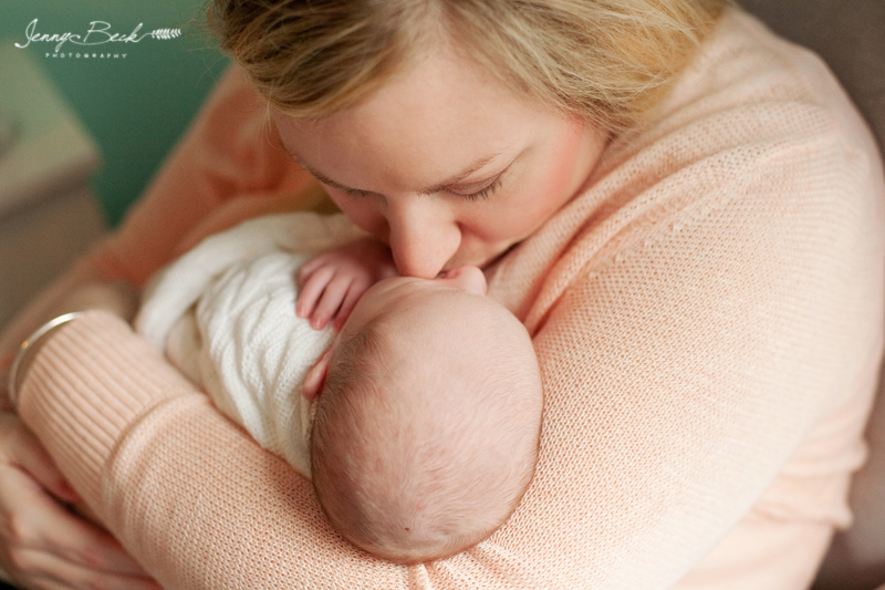westerville ohio newborn photographer - mom holding baby and kissing baby