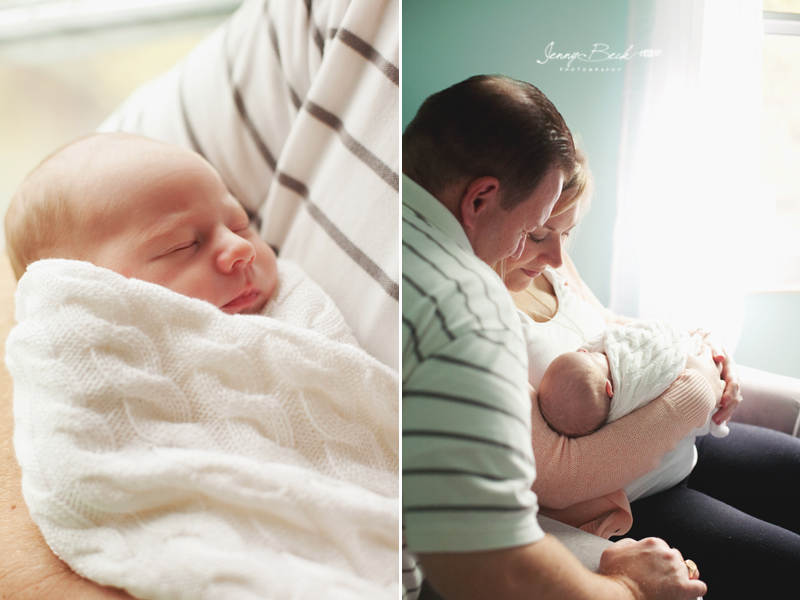 westerville ohio newborn photographer - baby swaddle in dad's arms and mom and dad looking down at baby