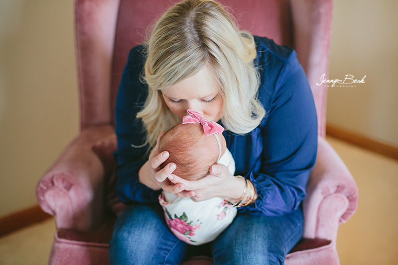 westerville ohio newborn photographer - new mom leaning forward kissing newborn