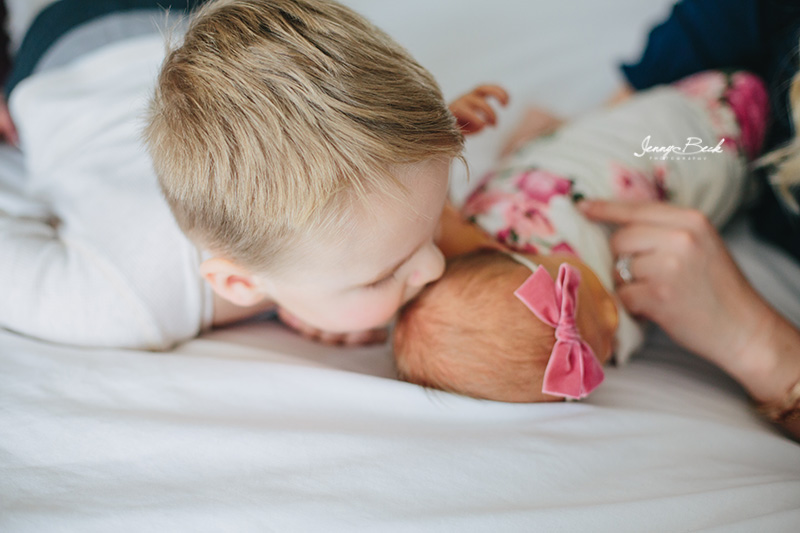 westerville ohio newborn photographer - close up of big brother kissing new baby