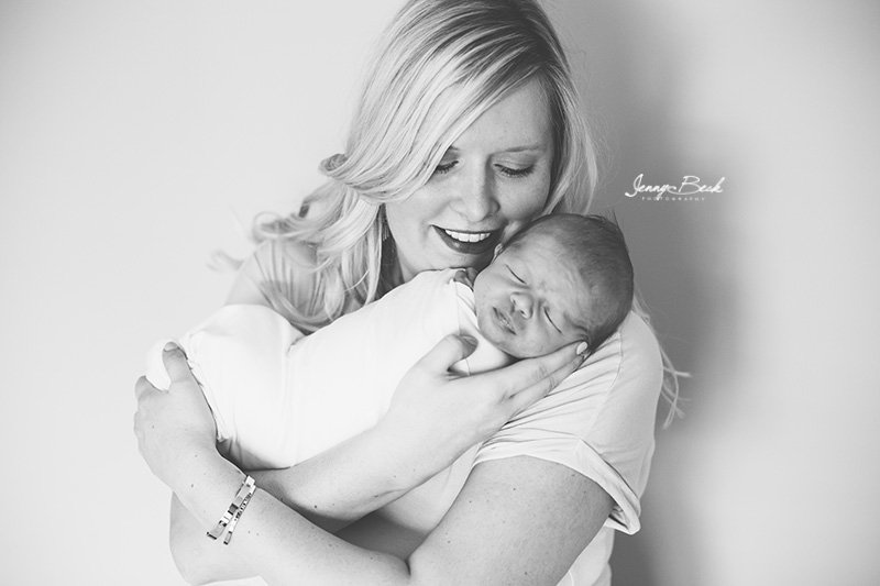 westerville ohio newborn photographer - black and white close up of mom holding baby close to her cheek
