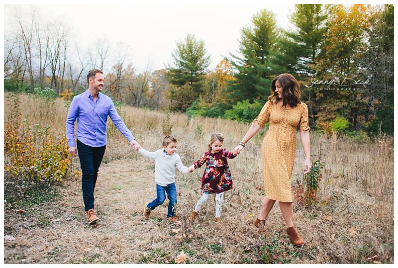family walking and holding hands for fall family pictures