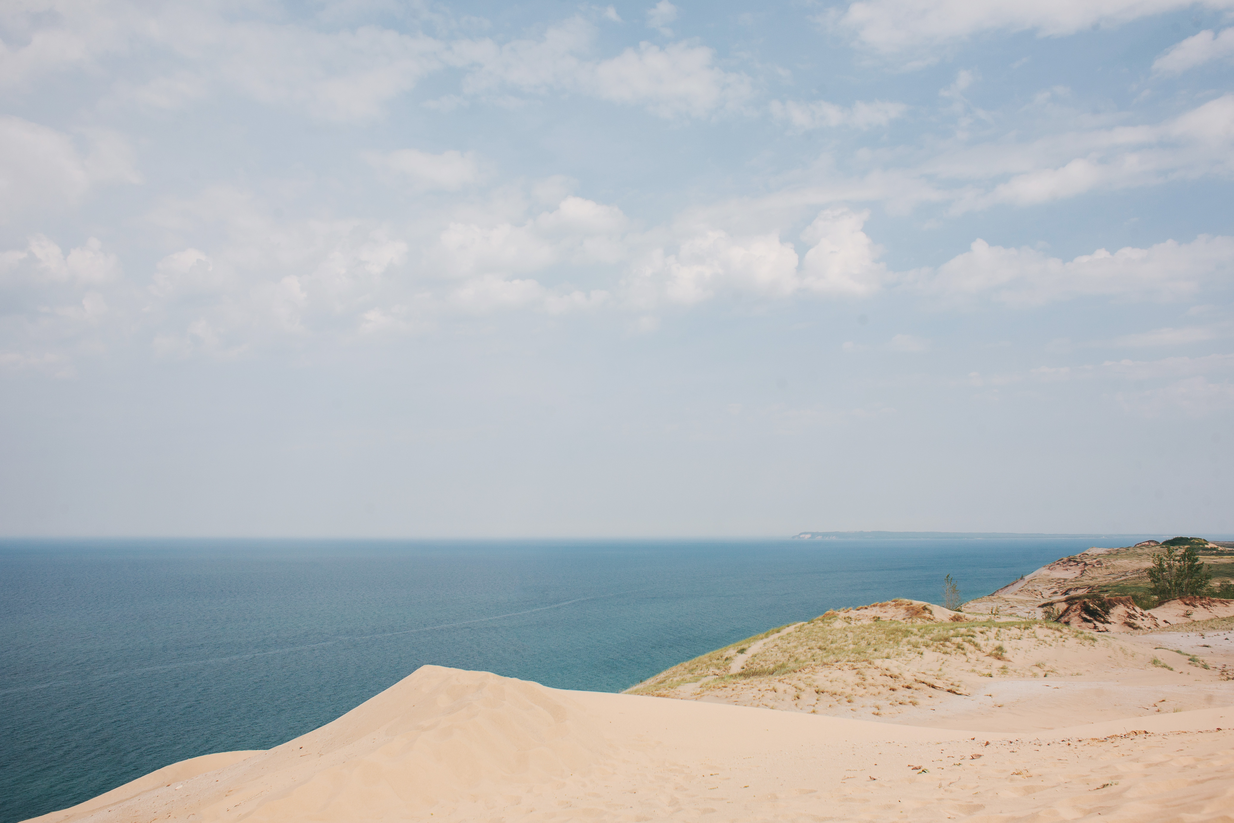 scenery of sand dunes with blue lake michigan waters behind