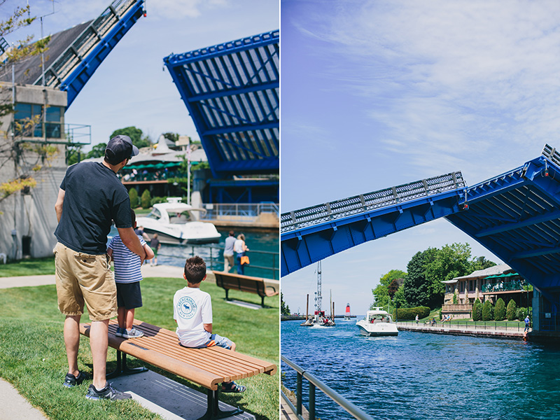 dad and two boys watching charlevoix michigan's draw bridge go up