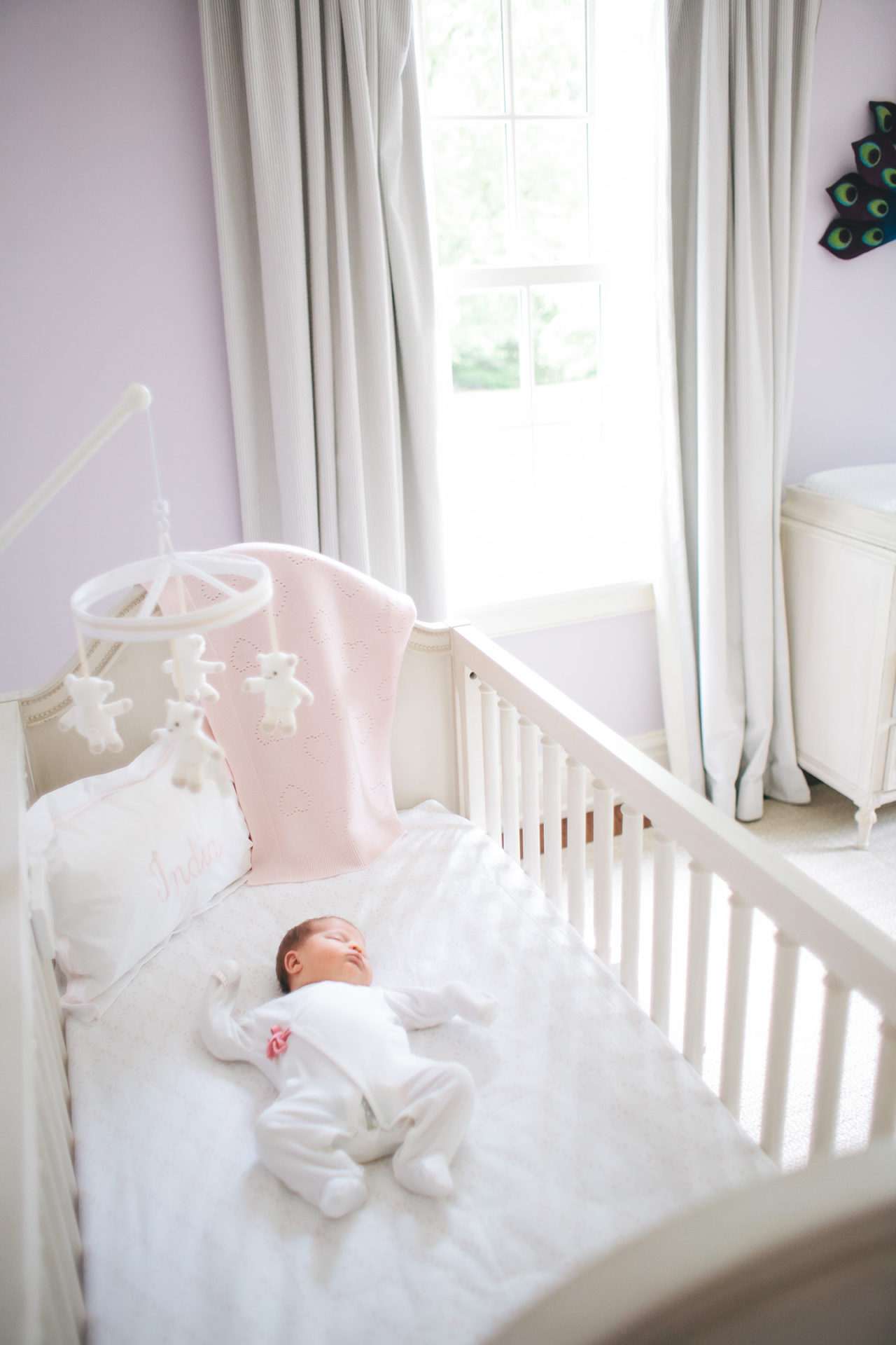 newborn baby sleeping peacefully in crib for newborn photos