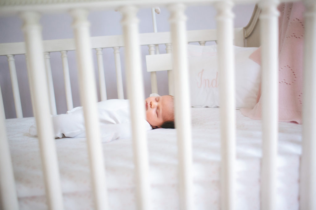 newborn baby sleeping in crib during in-home newborn photos