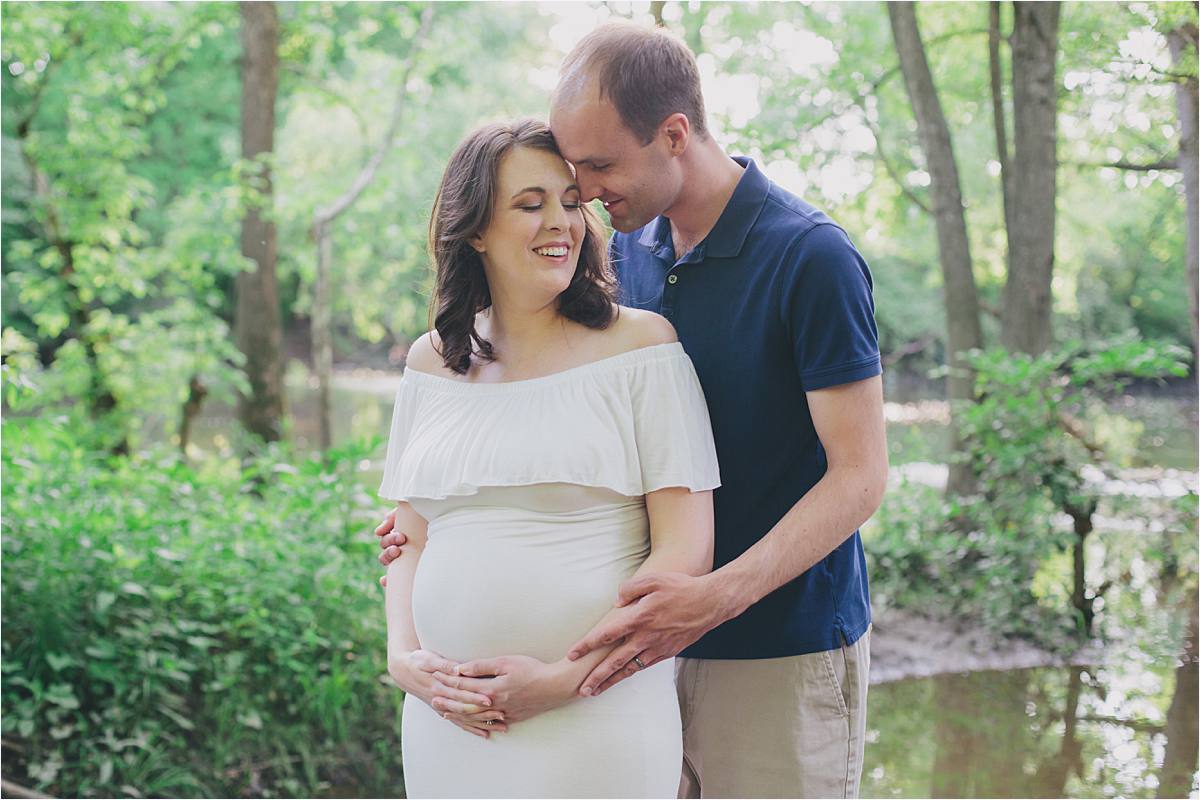 new albany ohio maternity photographer - pregnant mom in white dress touching heads with husband in nature