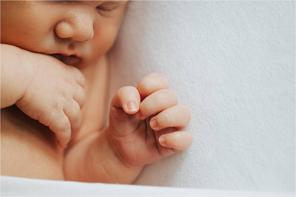 westerville ohio minimal newborn photographer - natural baby laying on side closeup of hands