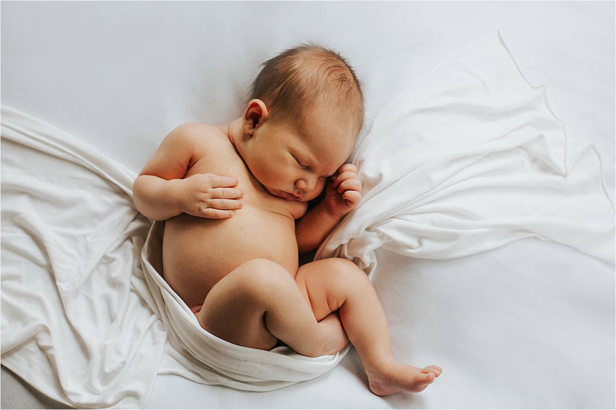Westerville ohio minimal newborn photographer - natural naked baby laying on organic white backdrop