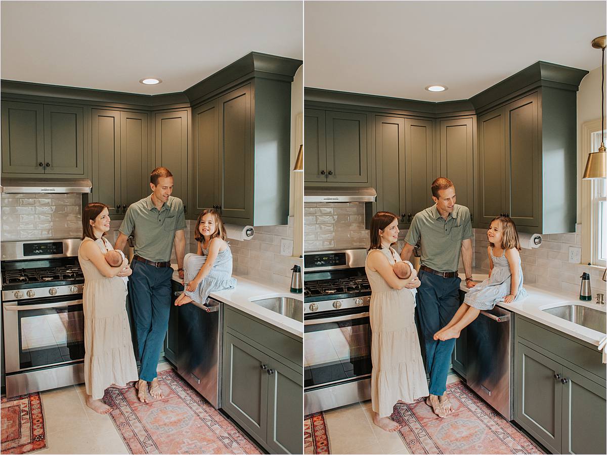 new family of four posing in green kitchen with new baby